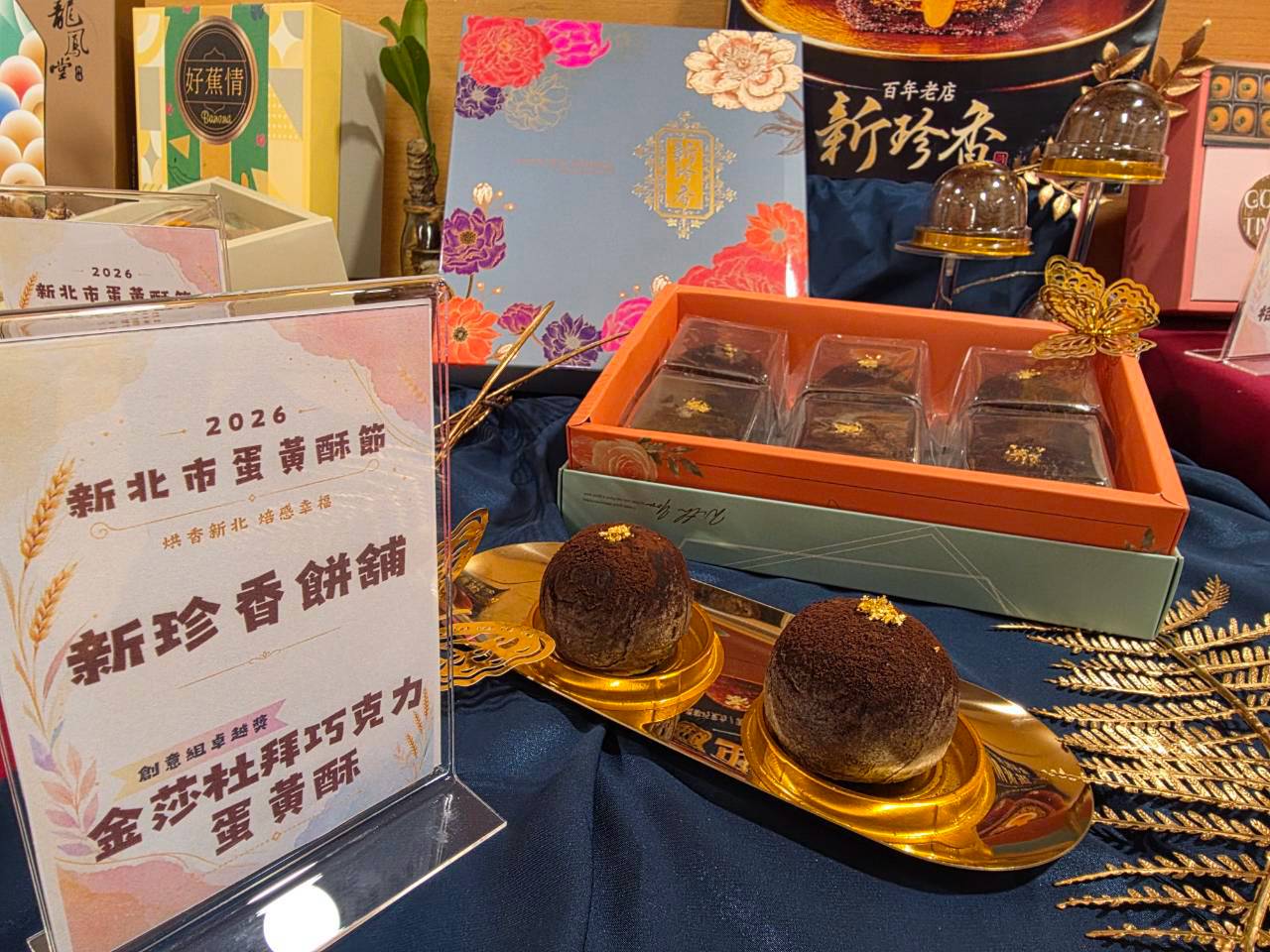 新珍香餅舖「金莎杜拜巧克力蛋黃酥」,巧克力千層酥皮搭配開心果、麻糬與流心鹹蛋黃,呈現酥、脆、Q、流心四重口感,兼具創意、美感與高級伴手禮特色。